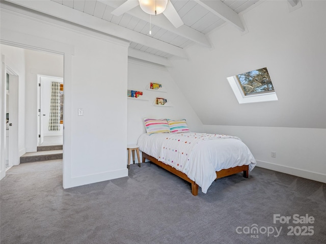 carpeted bedroom featuring vaulted ceiling with skylight and ceiling fan