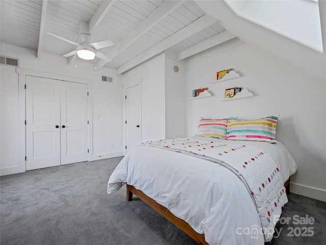 carpeted bedroom with a closet, ceiling fan, wood ceiling, and beam ceiling