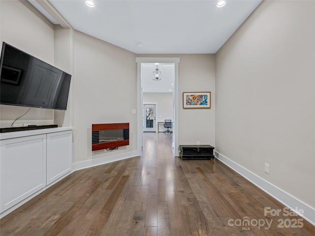 unfurnished living room featuring a fireplace and wood-type flooring