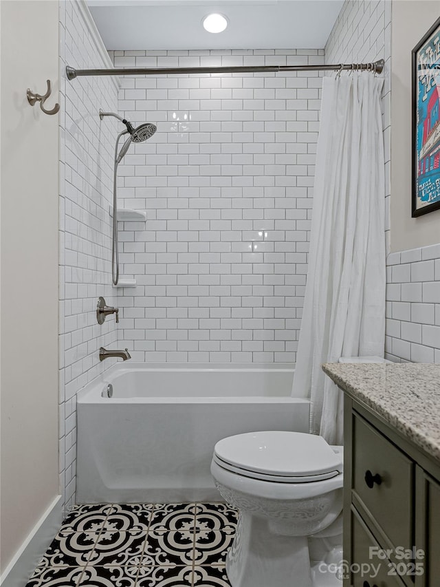 full bathroom with shower / bath combo, tile patterned floors, vanity, and toilet