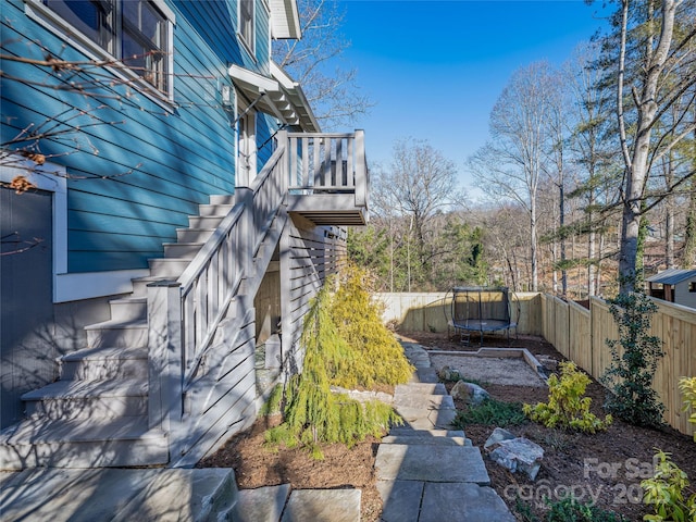 view of property exterior with a trampoline