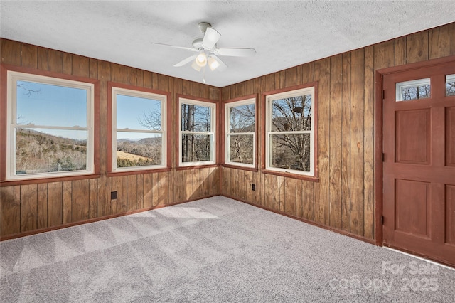 unfurnished sunroom featuring plenty of natural light and ceiling fan