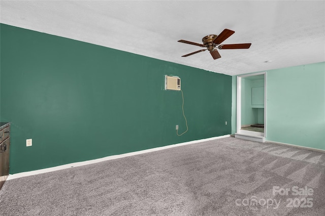 unfurnished bedroom featuring carpet, a wall mounted AC, a textured ceiling, and ceiling fan