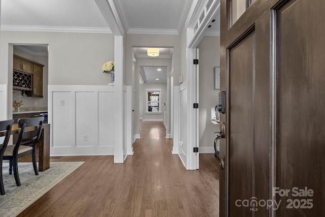 entryway featuring bar, dark hardwood / wood-style floors, and crown molding