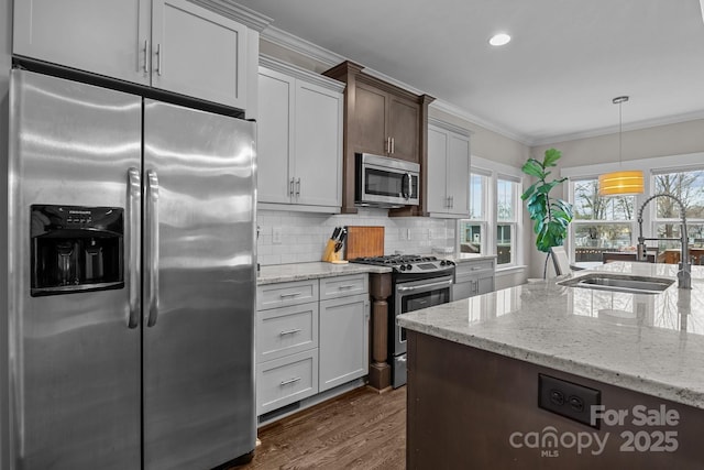 kitchen with decorative backsplash, sink, appliances with stainless steel finishes, and light stone countertops