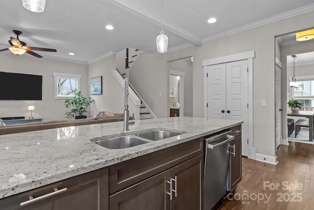 kitchen with hanging light fixtures, stainless steel dishwasher, sink, dark brown cabinets, and dark hardwood / wood-style flooring