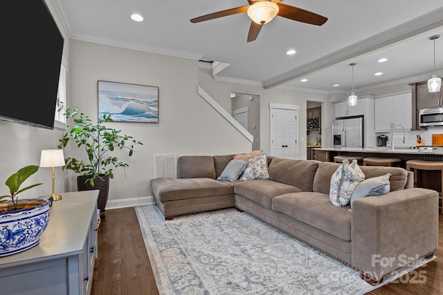 living room with light hardwood / wood-style floors, sink, crown molding, and ceiling fan