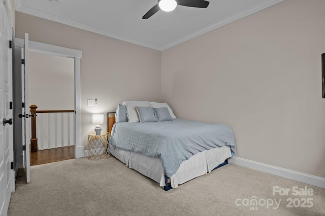 carpeted bedroom with ceiling fan and ornamental molding