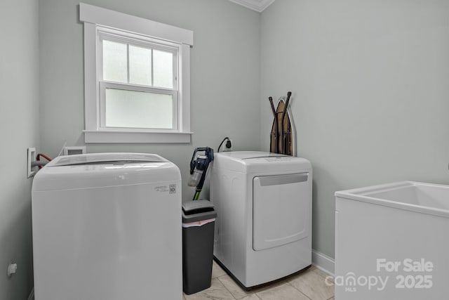 clothes washing area with light tile patterned floors and washing machine and clothes dryer