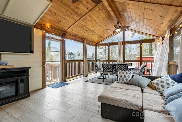 sunroom / solarium featuring vaulted ceiling, ceiling fan, and wooden ceiling