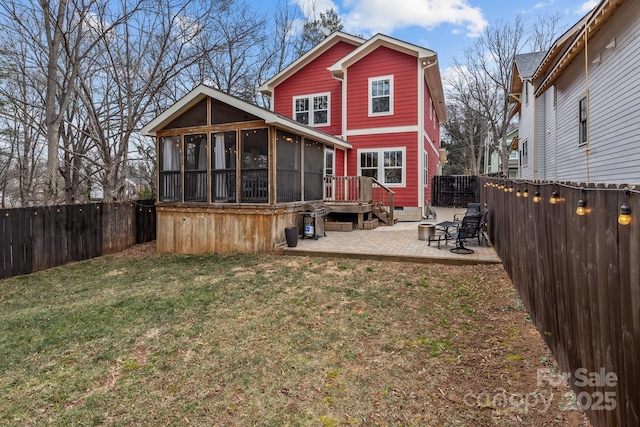 back of property with a patio, a yard, and a sunroom