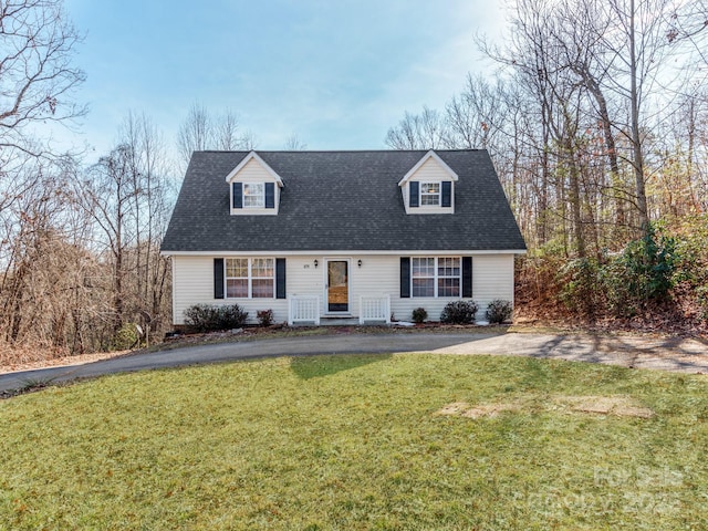 cape cod home with a front yard