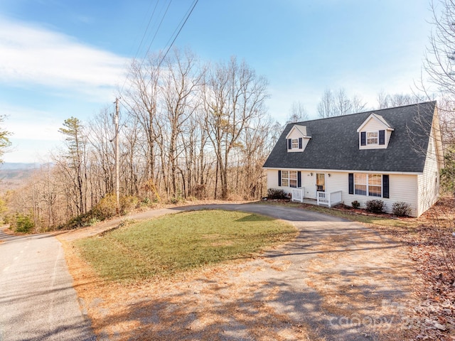 cape cod home featuring a front yard