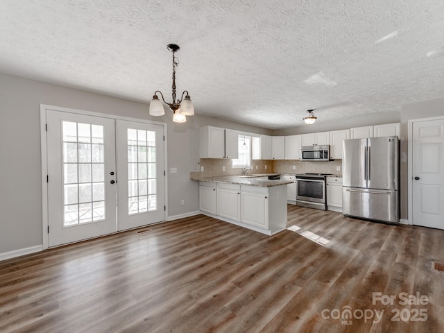 kitchen featuring stainless steel appliances, sink, white cabinets, and dark hardwood / wood-style flooring