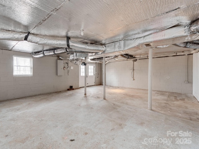 basement with a healthy amount of sunlight and electric panel