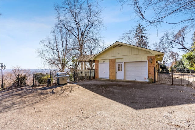 detached garage with driveway and fence