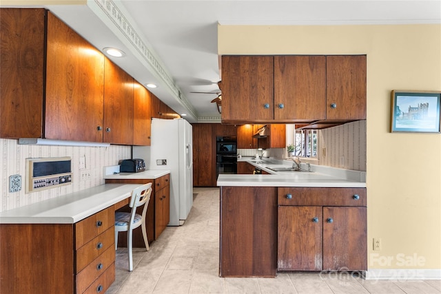 kitchen with light countertops, white refrigerator with ice dispenser, dobule oven black, and decorative backsplash