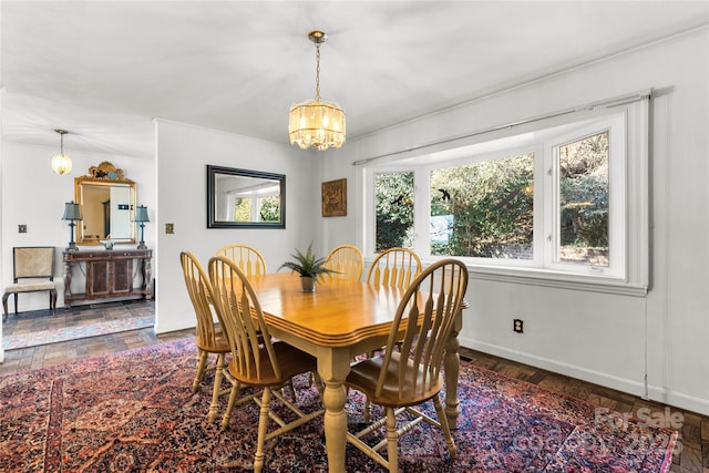 dining room featuring baseboards and an inviting chandelier