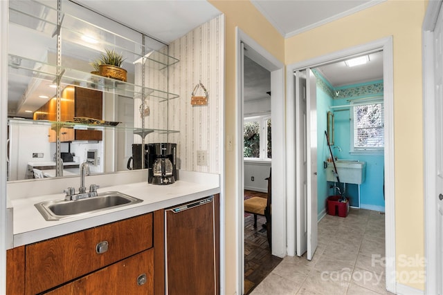 bar with dishwashing machine, light tile patterned flooring, a sink, and a wealth of natural light