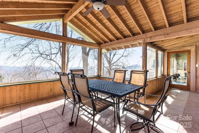 sunroom featuring a ceiling fan, wooden ceiling, plenty of natural light, and lofted ceiling with beams