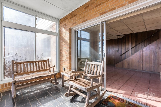 sunroom / solarium featuring a drop ceiling