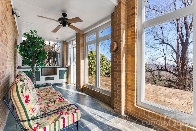 sunroom featuring ceiling fan