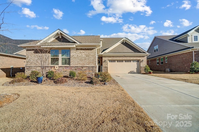 view of front of house with brick siding, concrete driveway, roof with shingles, a garage, and stone siding