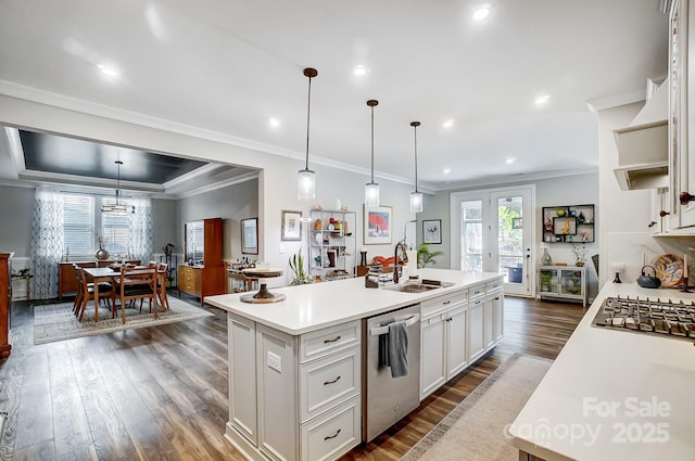 kitchen with white cabinets, appliances with stainless steel finishes, light countertops, and dark wood-type flooring