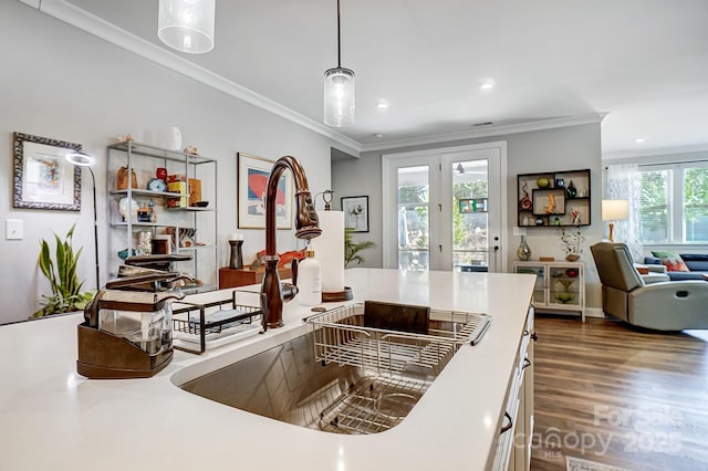 kitchen featuring crown molding, dark wood-type flooring, pendant lighting, recessed lighting, and a sink