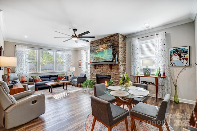 9428 Liberty Hill Dr, Mint Hill, NC 28227 - living area featuring crown molding, healthy amount of natural light, ceiling fan, a stone fireplace, and wood finished floors