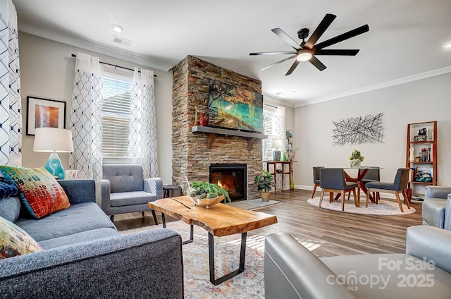 9428 Liberty Hill Dr, Mint Hill, NC 28227 - living area with crown molding, wood finished floors, ceiling fan, a stone fireplace, and baseboards