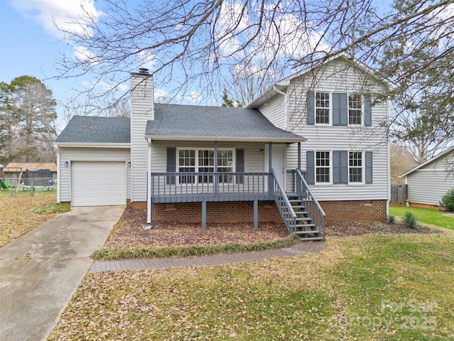 view of front facade with a garage, a front lawn, and covered porch