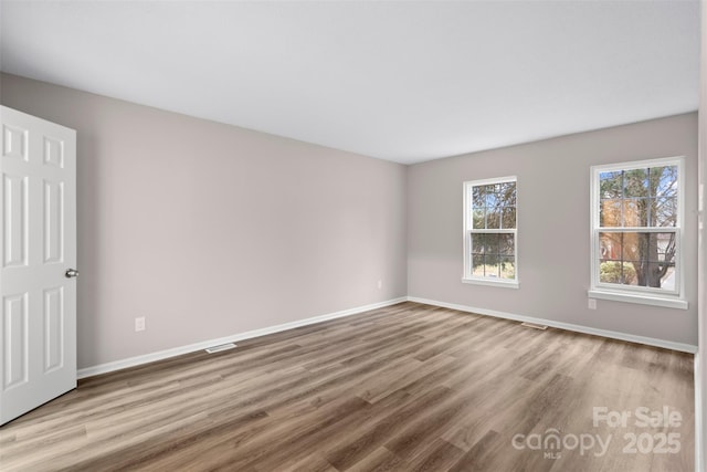 spare room featuring light hardwood / wood-style flooring