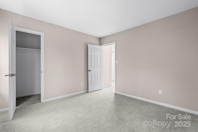 unfurnished bedroom featuring a closet and light carpet