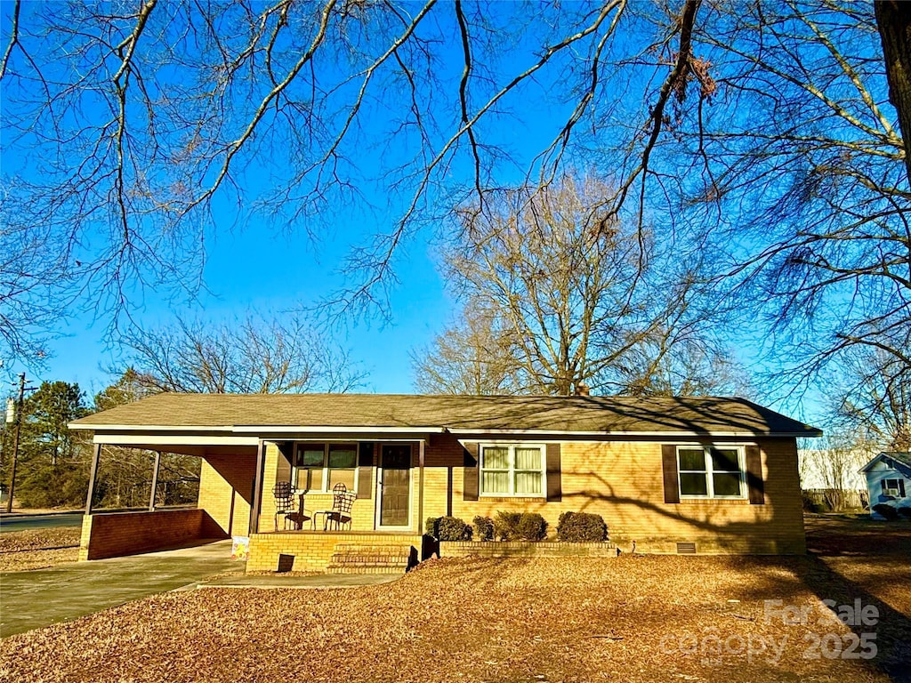 view of front of house featuring a carport and covered porch