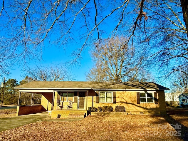 view of front of house featuring a carport and covered porch