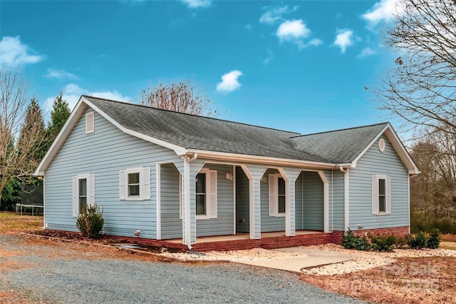 single story home featuring a trampoline and a porch