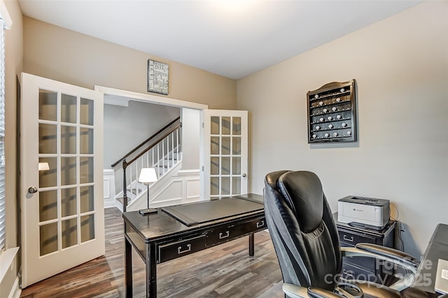 office with wood-type flooring and french doors