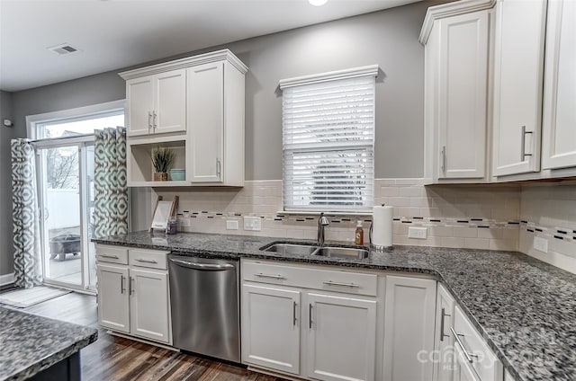 kitchen featuring tasteful backsplash, dishwasher, sink, and white cabinets