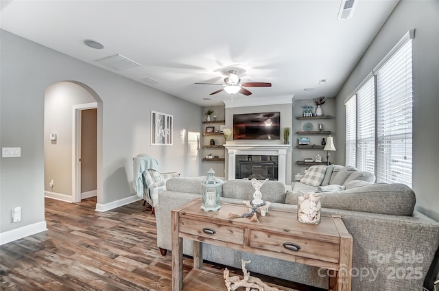 living room with wood-type flooring and ceiling fan