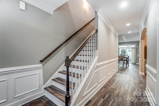 stairway with crown molding and hardwood / wood-style floors