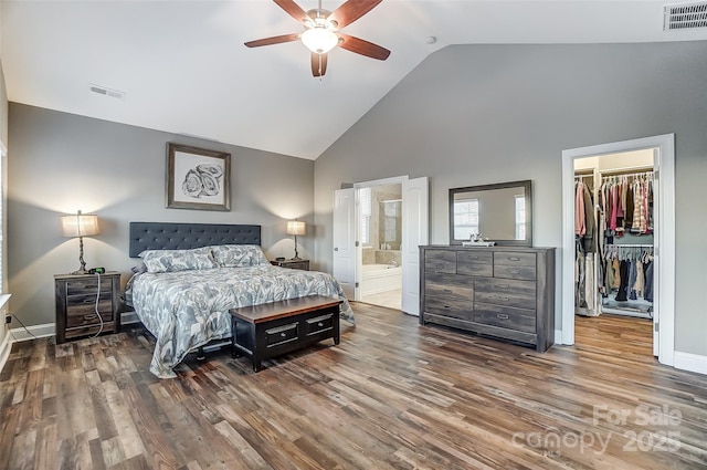 bedroom featuring ensuite bathroom, wood-type flooring, a walk in closet, ceiling fan, and a closet