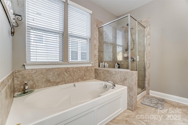 bathroom with tile patterned floors and shower with separate bathtub