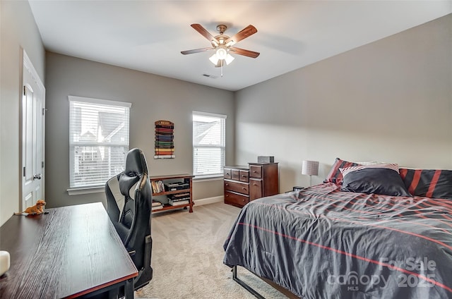 bedroom with light colored carpet and ceiling fan