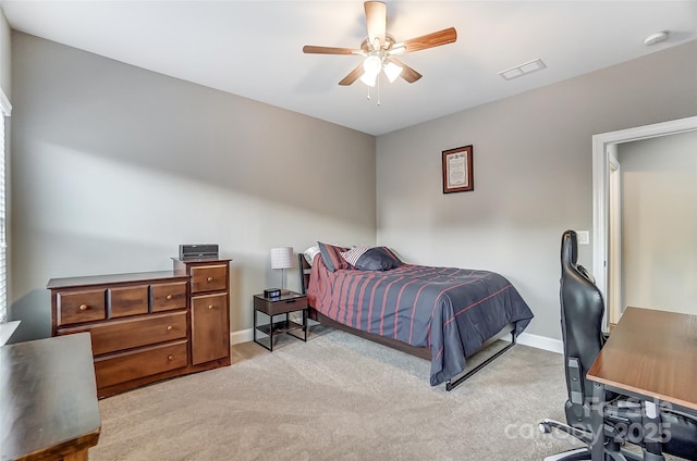 bedroom with ceiling fan and light carpet