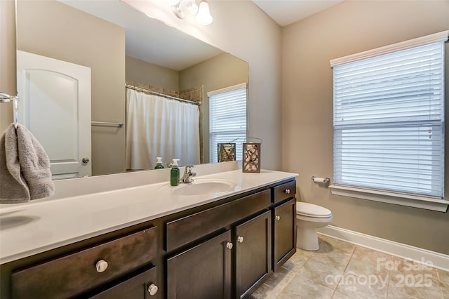 bathroom with vanity, tile patterned floors, and toilet