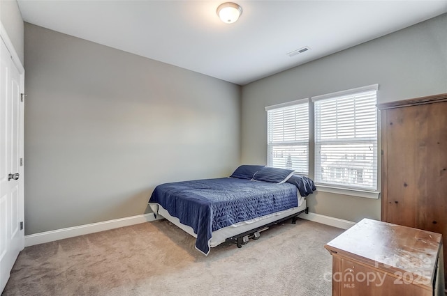 bedroom featuring light carpet