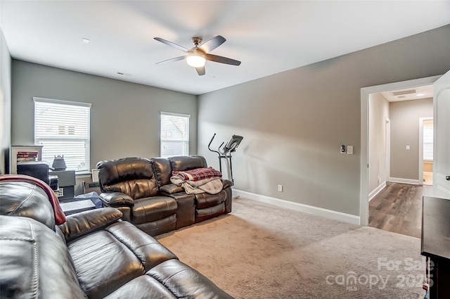 living room featuring a wealth of natural light and ceiling fan