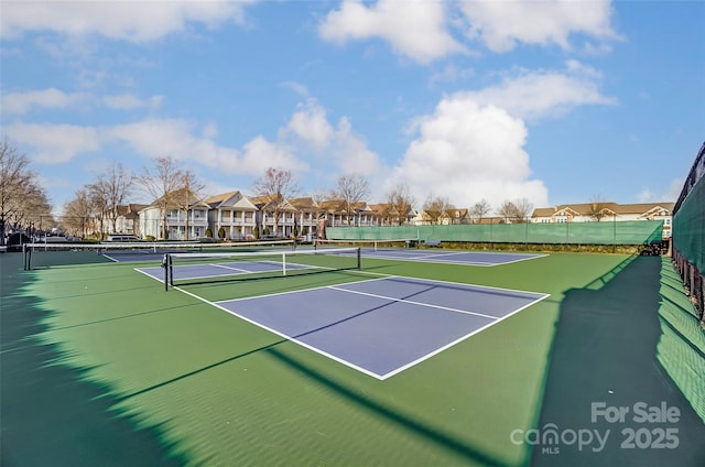 view of tennis court featuring basketball hoop