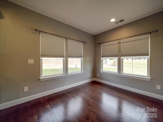 spare room featuring dark wood-type flooring